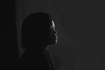 a black and white photo of a person in the dark