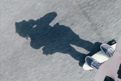 a shadow of a person riding a skateboard