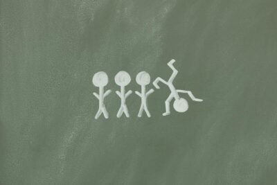 Illustration of stick figures on a chalkboard, symbolizing diversity and inclusion.