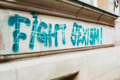 Street graffiti promoting equality with 'Fight Sexism!' message.