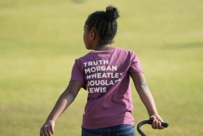 a young girl with a t - shirt that says truth morgan wheatley douglas lewis