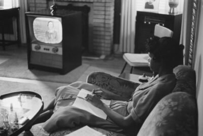 An African American high school girl being educated via television during the period that the Little Rock schools were closed to avoid integration.