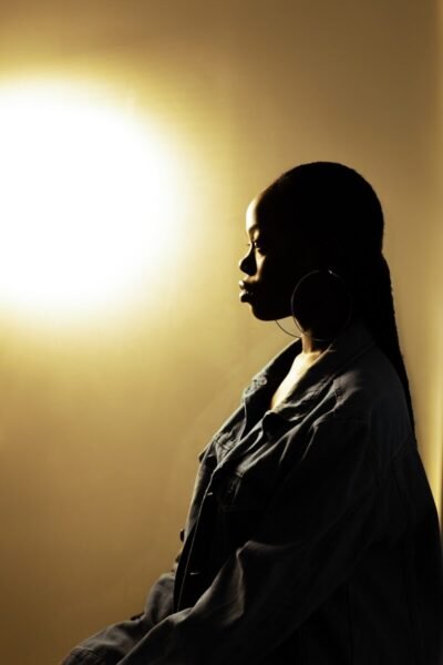 a woman standing in front of a light