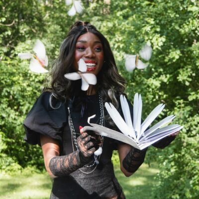 a woman in a costume holding an open book